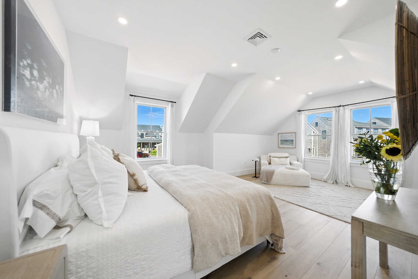 10 Beach Grass Road Nantucket, MA 02554 - Photo 13 of 29 a spacious bedroom with a bed and a potted plant