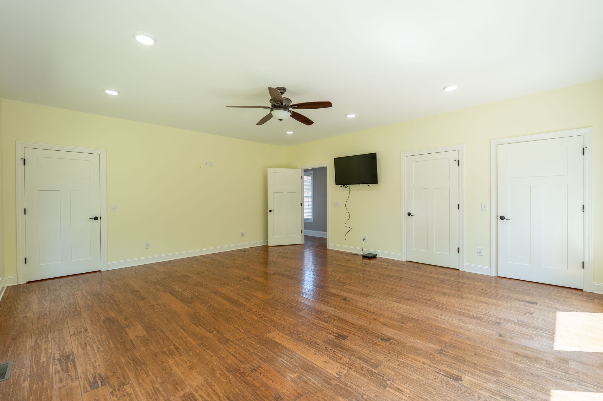 219 Waterloo Street Lawrenceburg, TN 38464 - Photo 26 of 39 wooden floor in an empty room with a ceiling fan