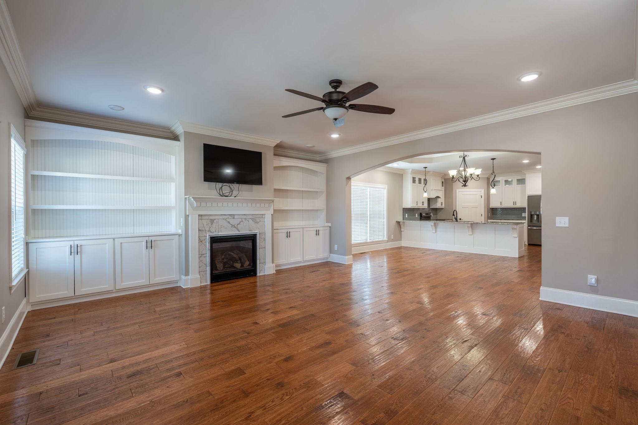 219 Waterloo Street Lawrenceburg, TN 38464 - Photo 5 of 39 a view of a livingroom with a fireplace a chandelier and wooden floor