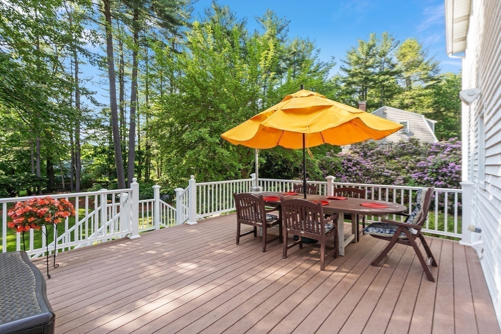 2 Pomfret Road Chelmsford, MA 01824 - Photo 32 of 38 a view of a deck with table and chairs under an umbrella with wooden floor