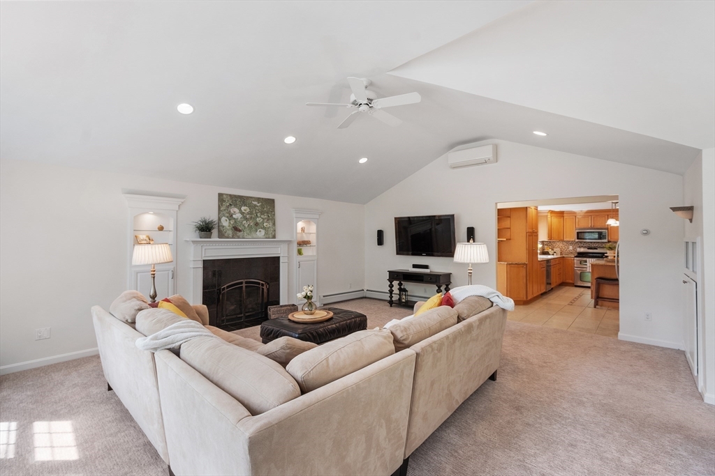 2 Pomfret Road Chelmsford, MA 01824 - Photo 5 of 38 a living room with furniture a flat screen tv and a fireplace