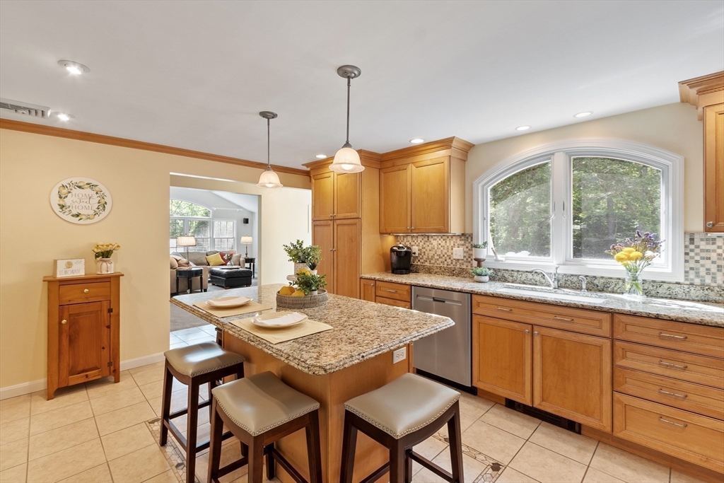 2 Pomfret Road Chelmsford, MA 01824 - Photo 9 of 38 a kitchen with granite countertop a table chairs stove and sink