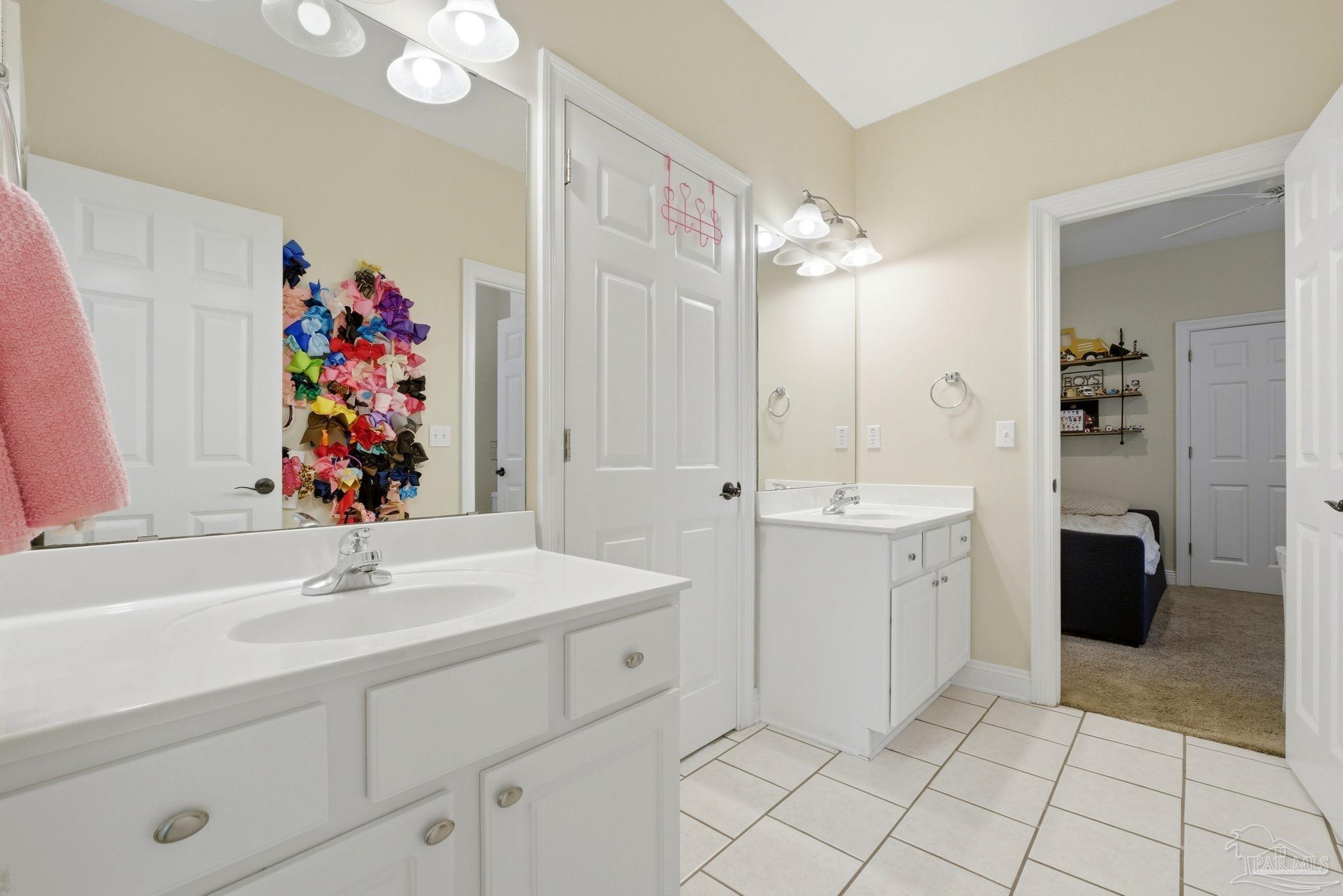 5931 Otter Point Road Pensacola, FL 32504 - Photo 26 of 67 a bathroom with a sink vanity and mirror
