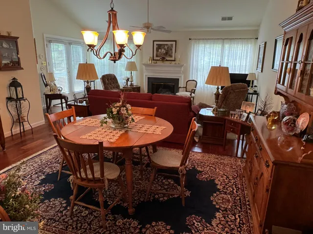 a dining room with furniture a rug and wooden floor