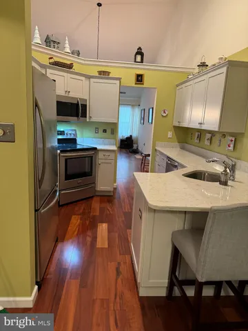 a kitchen with a sink appliances and cabinets