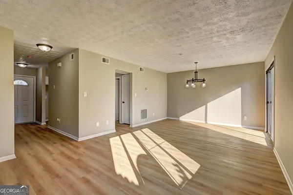 a view of an empty room and wooden floor