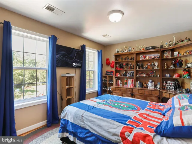 a living room with lots of furniture and a book shelf