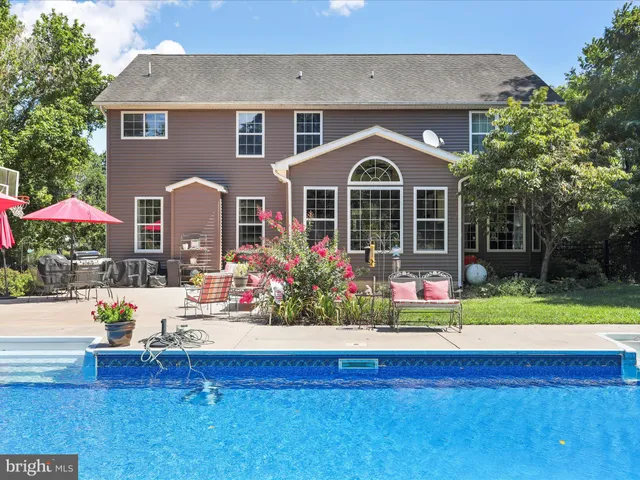 a view of a dining room with furniture a chandelier and wooden floor