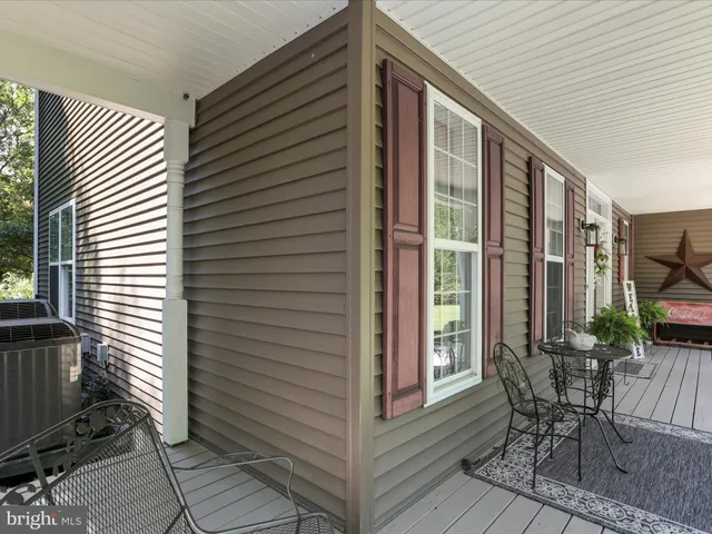 a view of hallway with wooden floor and stairs