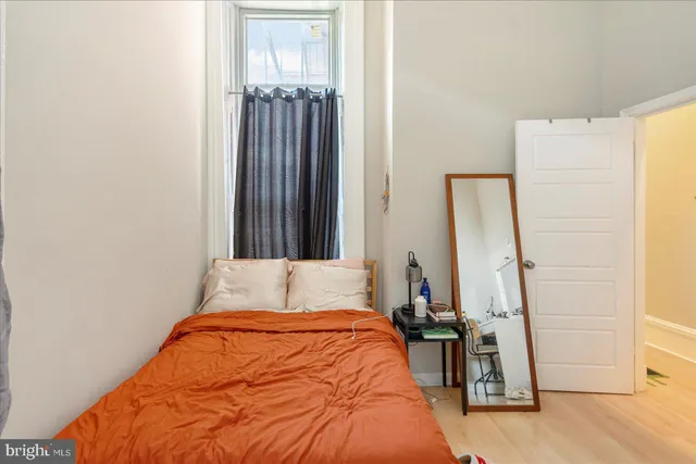 a kitchen with stainless steel appliances granite countertop a stove a sink dishwasher and a dining table with wooden floor