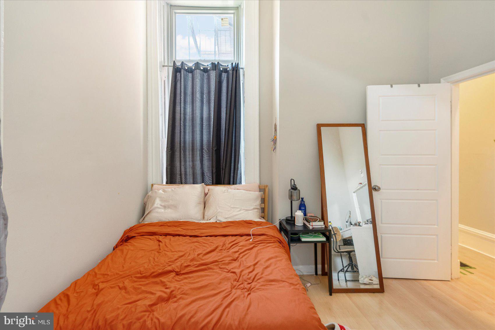 2304 Eutaw Place Baltimore, MD 21217 - Photo 14 of 105 a bed sitting in a bedroom next to a bathroom