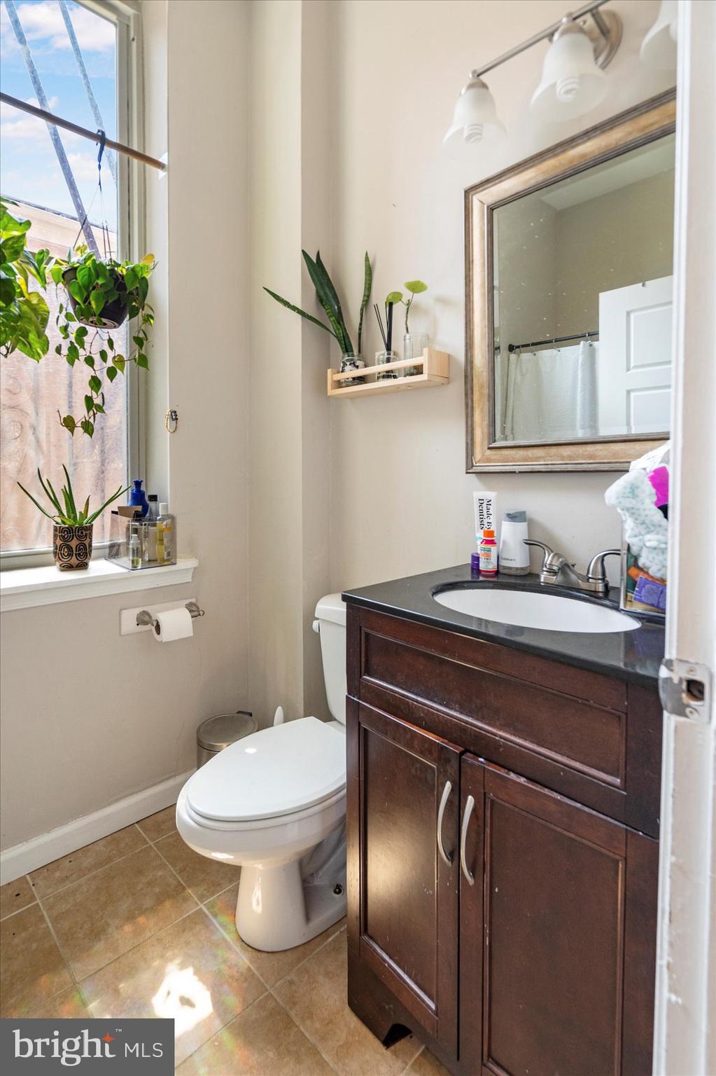 2304 Eutaw Place Baltimore, MD 21217 - Photo 18 of 105 a bathroom with a toilet sink and mirror