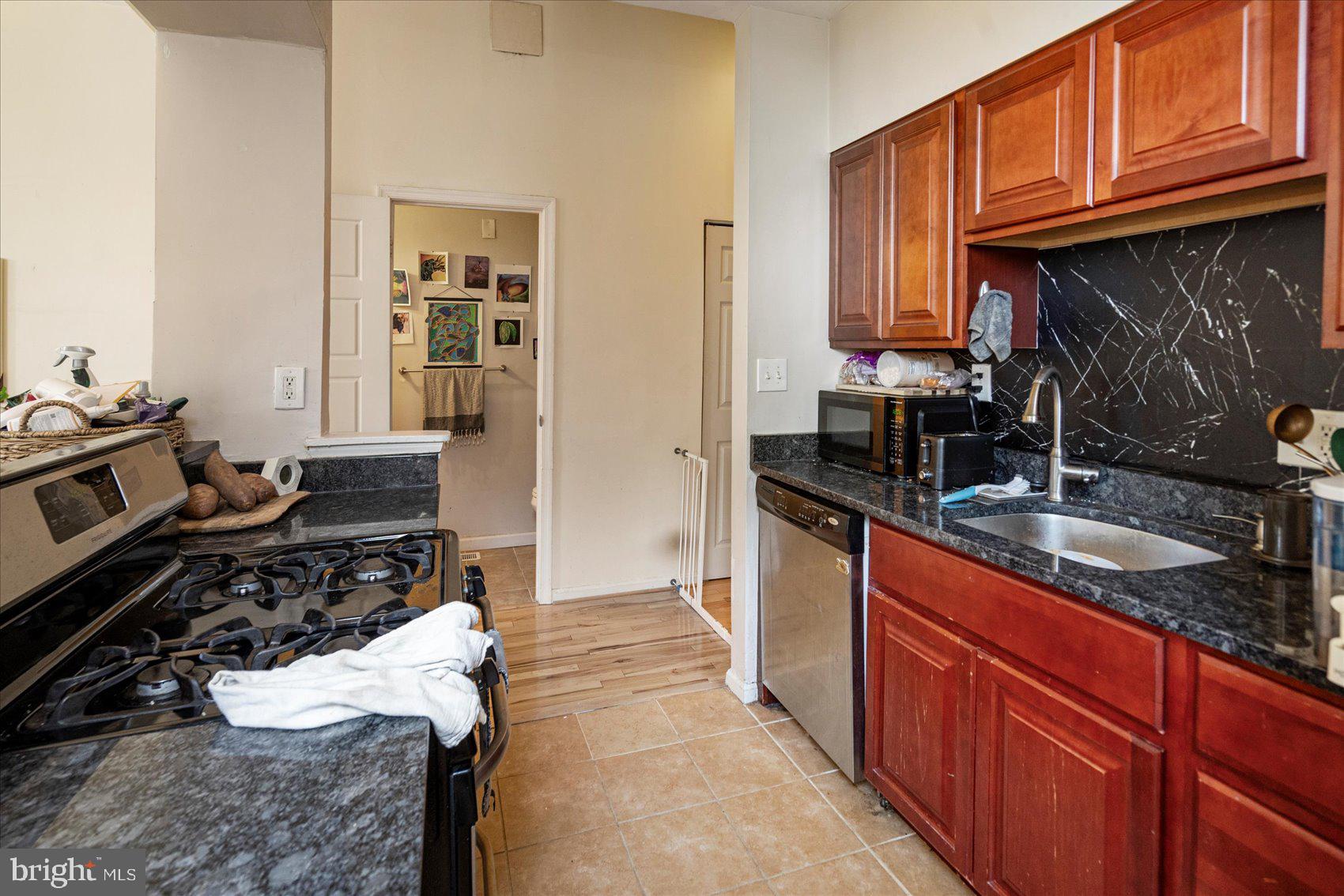 2304 Eutaw Place Baltimore, MD 21217 - Photo 31 of 105 a kitchen with a sink stove and cabinets
