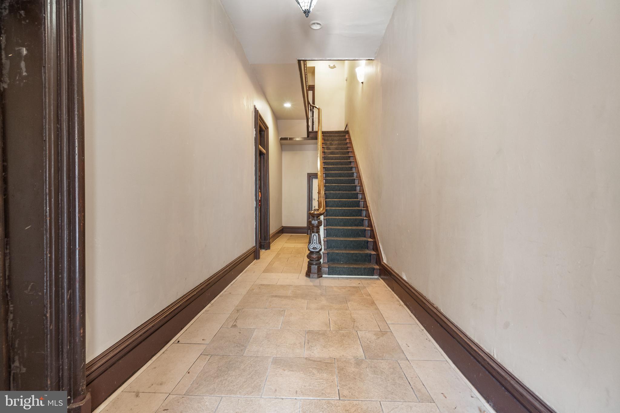 2304 Eutaw Place Baltimore, MD 21217 - Photo 4 of 105 a view of a hallway with wooden floor and stairs