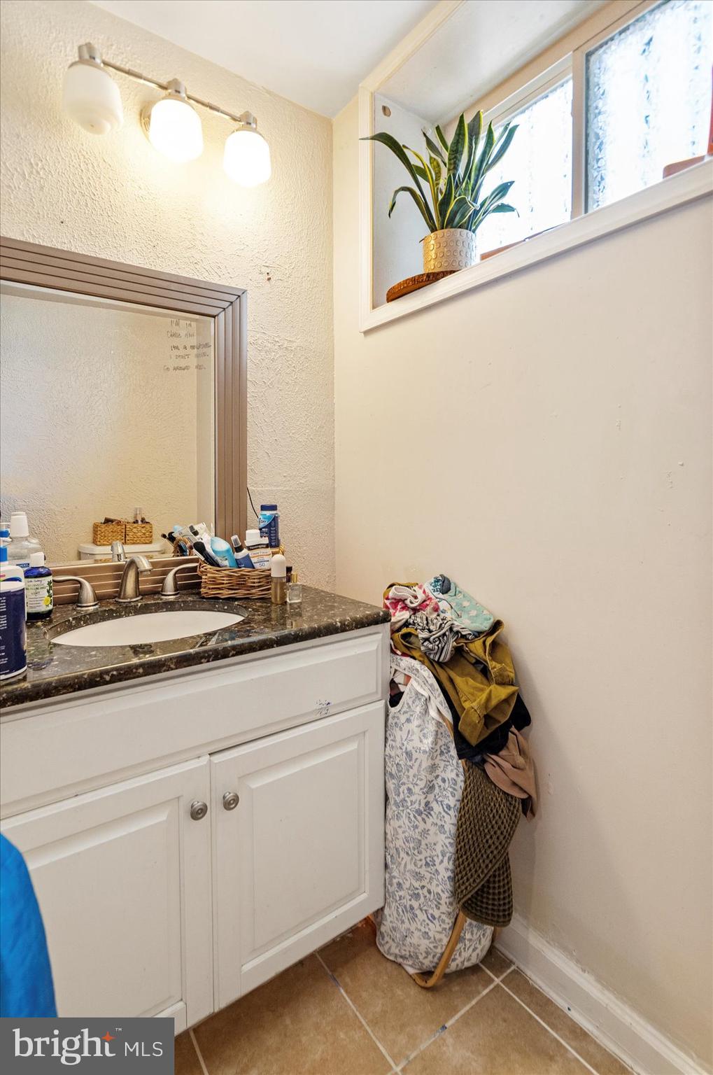 2304 Eutaw Place Baltimore, MD 21217 - Photo 42 of 105 a bathroom with a sink and a mirror
