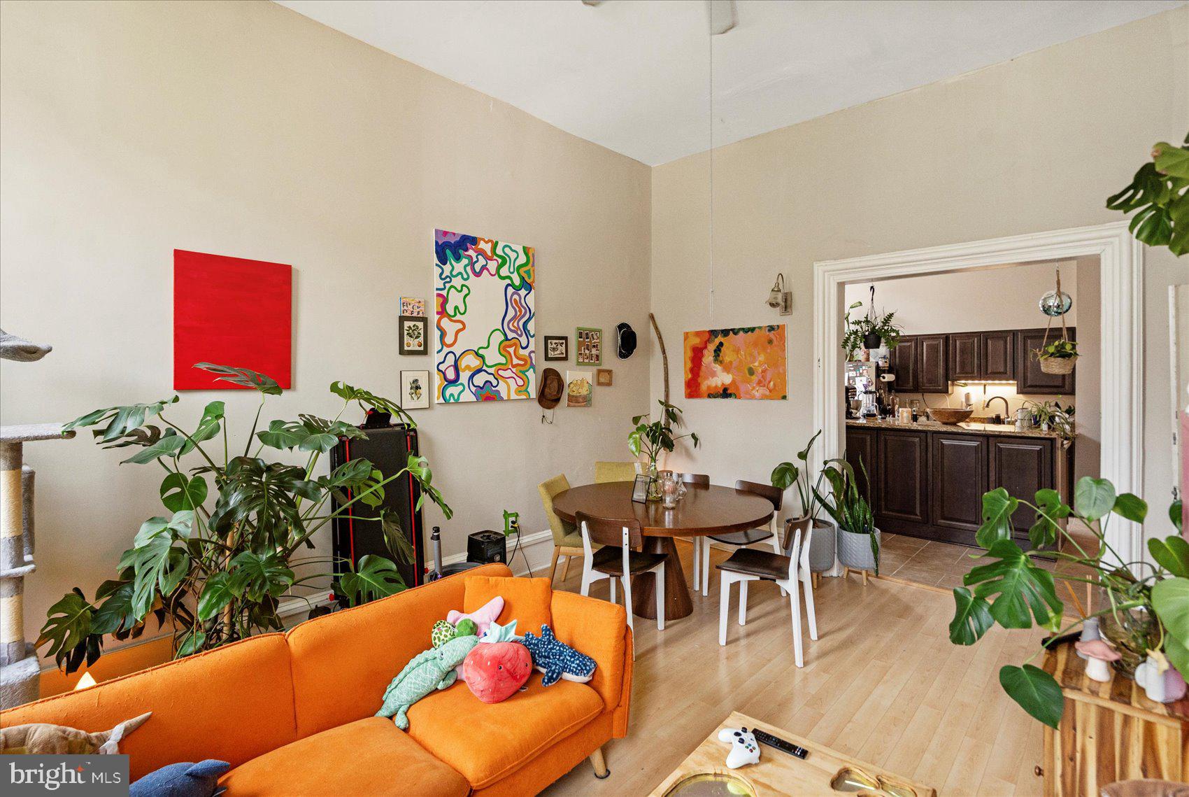 2304 Eutaw Place Baltimore, MD 21217 - Photo 8 of 105 a living room with furniture a potted plant and a wooden floor