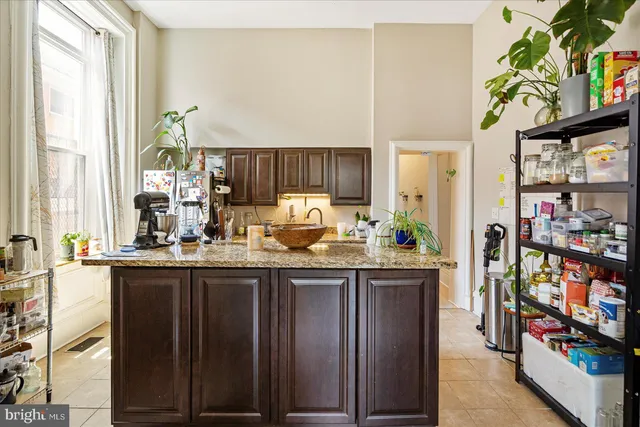 a bed sitting in a bedroom next to a bathroom