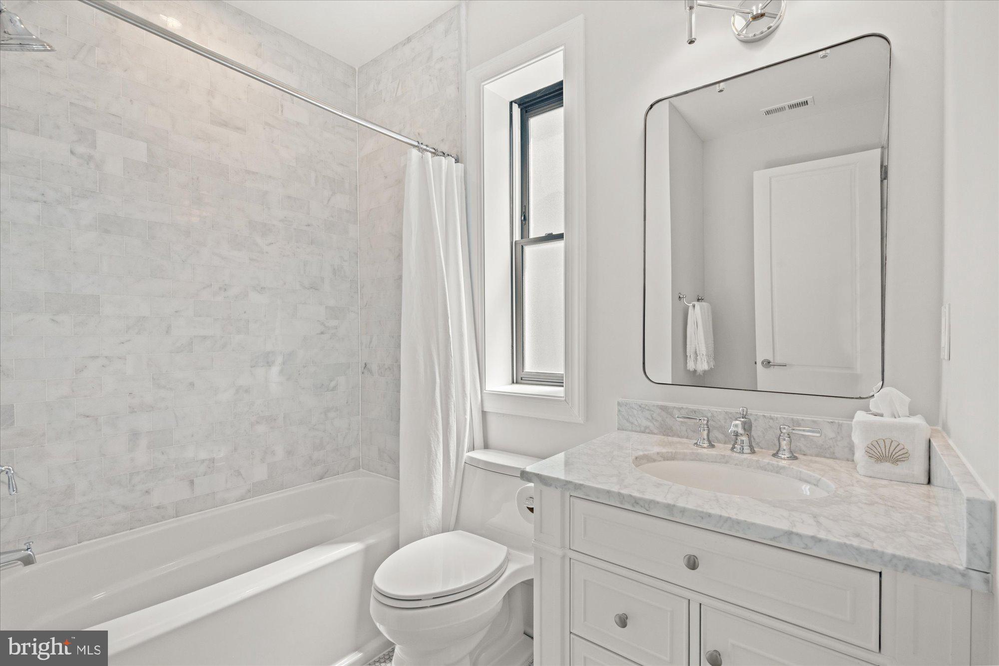2610 Garfield Street Northwest Washington, DC 20008 - Photo 27 of 51 a bathroom with a granite countertop sink a toilet and shower
