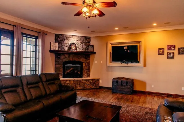 a living room with furniture a flat screen tv and a fireplace