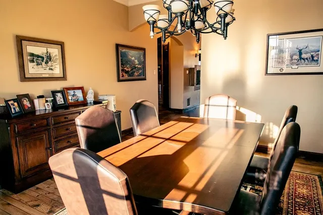 a dining room with furniture and wooden floor