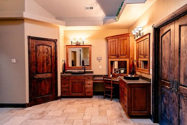 a kitchen with stainless steel appliances granite countertop a stove refrigerator and cabinets