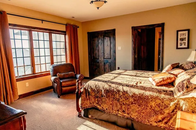 a bedroom with bed and glass windows