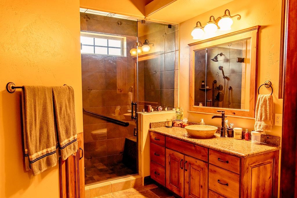 1230 Ridgeview Rangely, CO 81648 - Photo 28 of 42 a bathroom with a double vanity sink mirror and shower