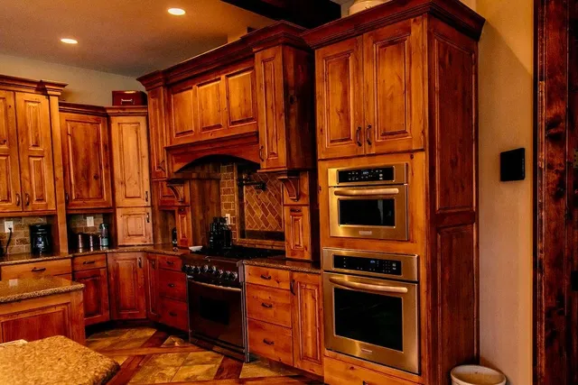 a kitchen with stainless steel appliances granite countertop a stove top oven