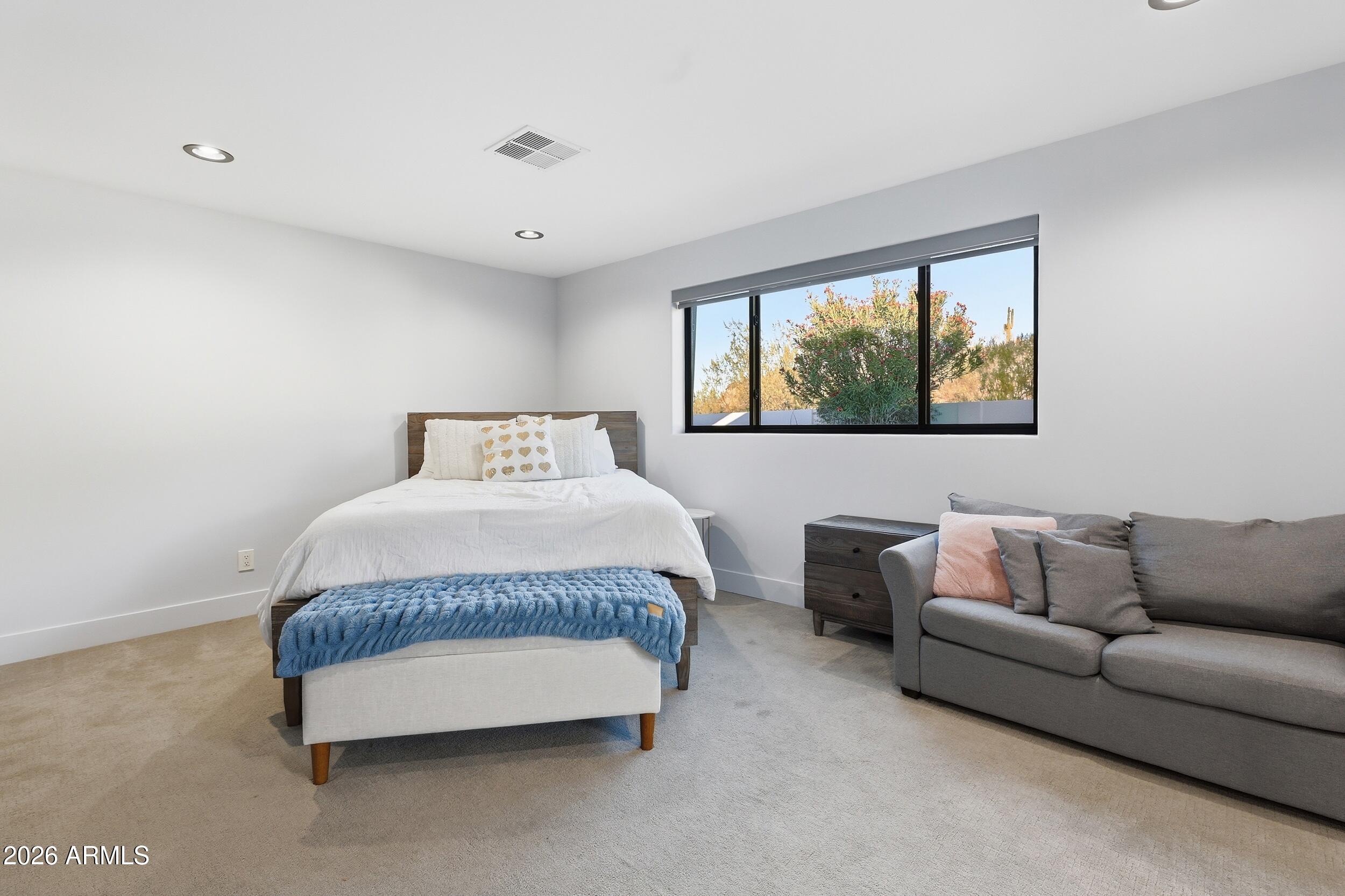 4417 East Mountain View Road Phoenix, AZ 85028 - Photo 26 of 41 a spacious bedroom with a bed and a couch