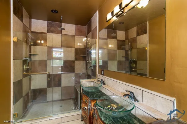 a bathroom with a shower and a mirror