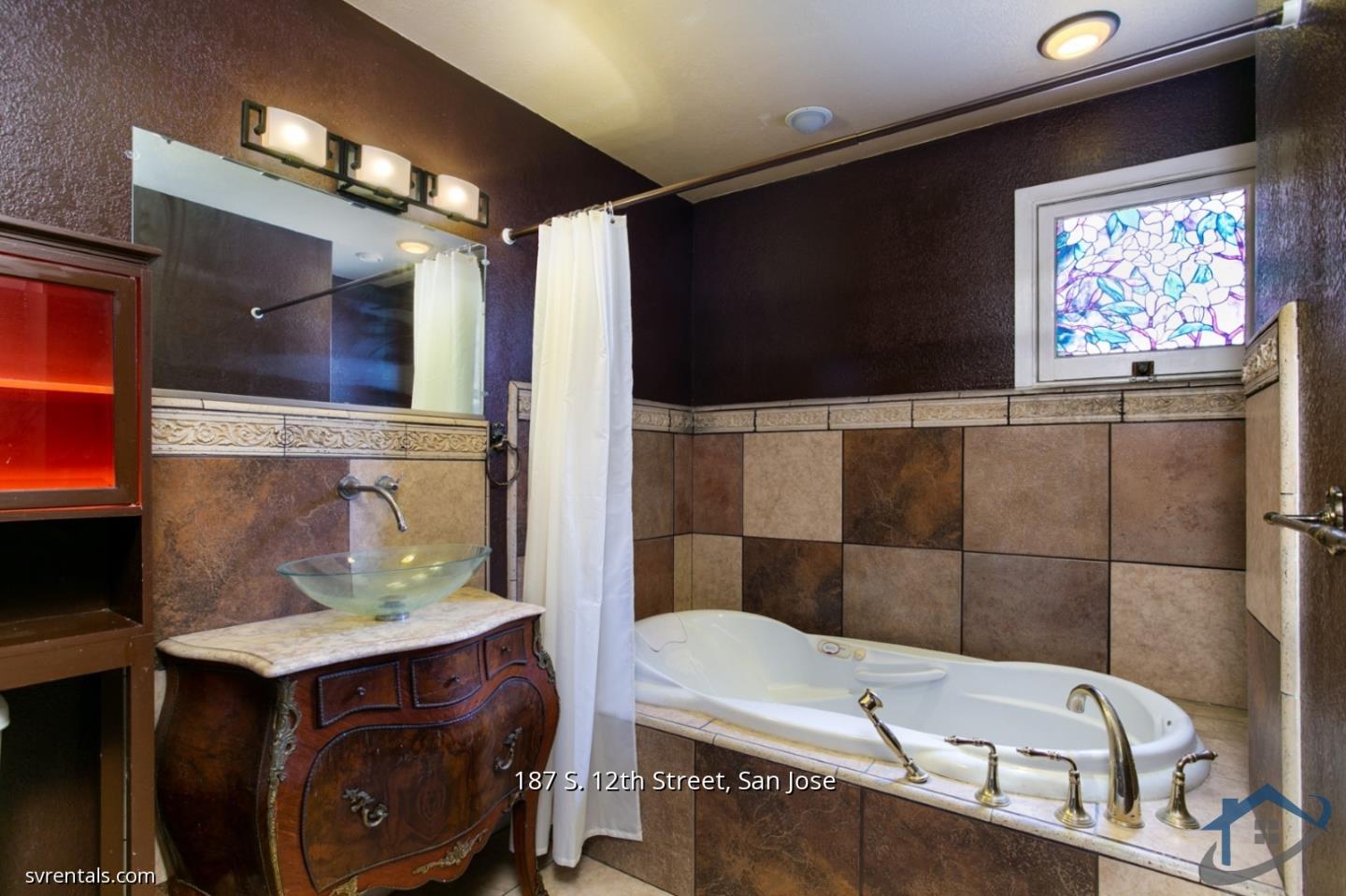 187 South 12th Street, Unit 2 San Jose, CA 95112 - Photo 21 of 24 a bathroom with a sink a mirror and a bathtub