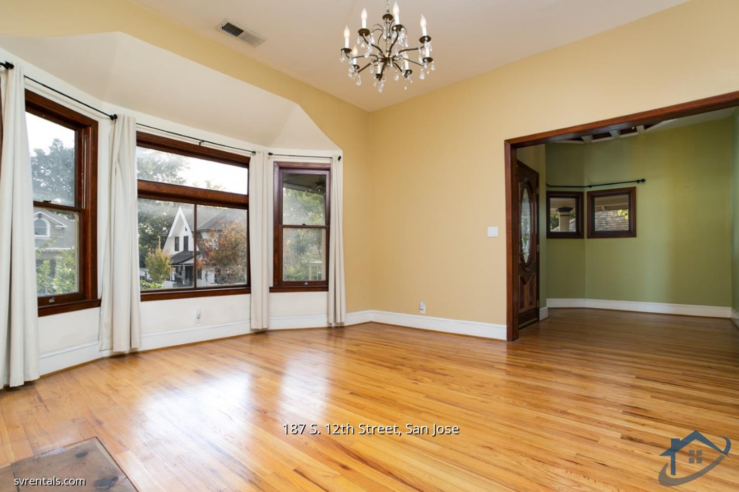 187 South 12th Street, Unit 2 San Jose, CA 95112 - Photo 7 of 24 a view of an empty room with wooden floor and a window