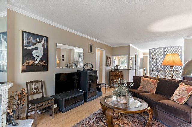 a living room with furniture a rug and a chandelier