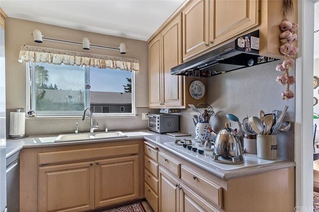 a kitchen with stainless steel appliances granite countertop a sink and cabinets