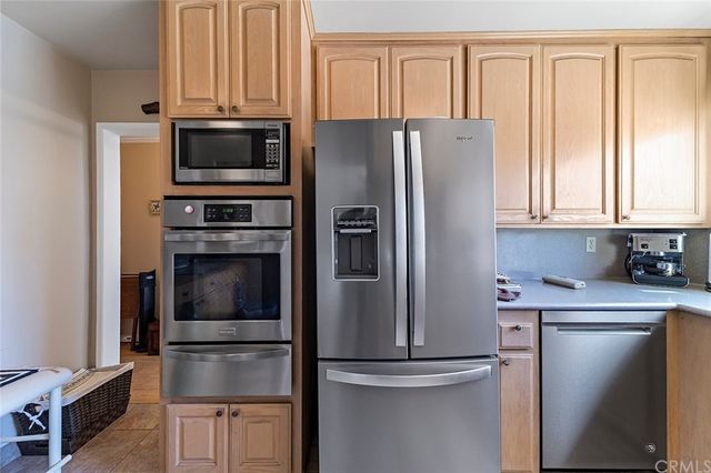 a kitchen with stainless steel appliances a refrigerator sink and cabinets