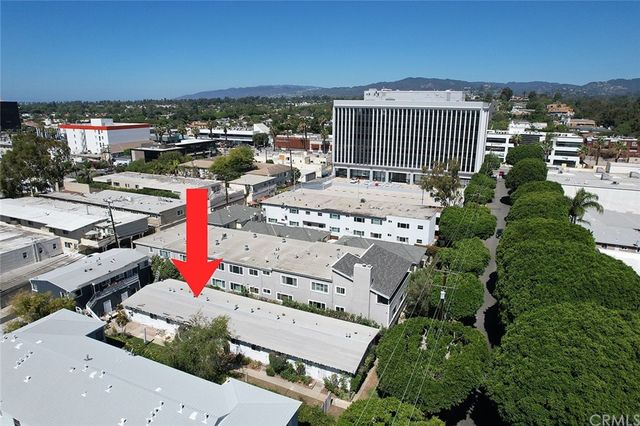 a dining room with furniture a chandelier and window