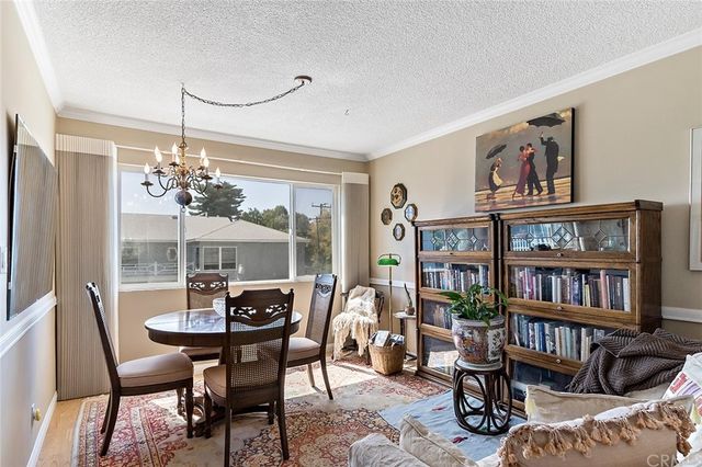 a living room with furniture and a book shelf