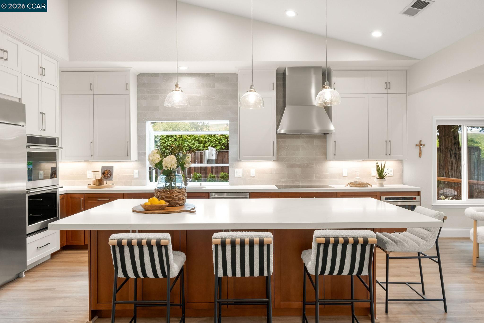 76 Rock Ridge Court Danville, CA 94526 - Photo 17 of 65 a kitchen with a table chairs stove and kitchen island