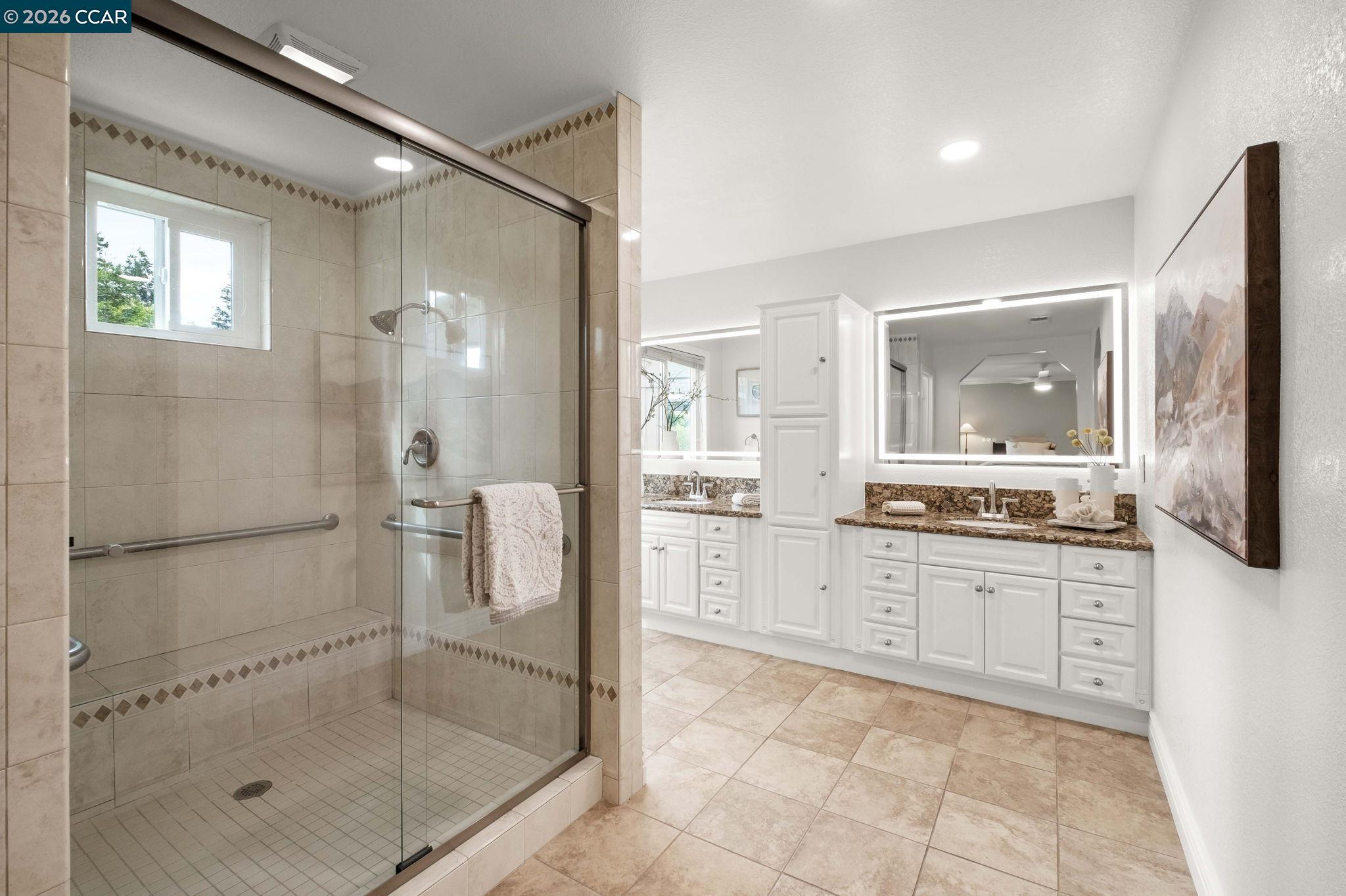 76 Rock Ridge Court Danville, CA 94526 - Photo 24 of 65 a large bathroom with a granite countertop shower a mirror and a sink