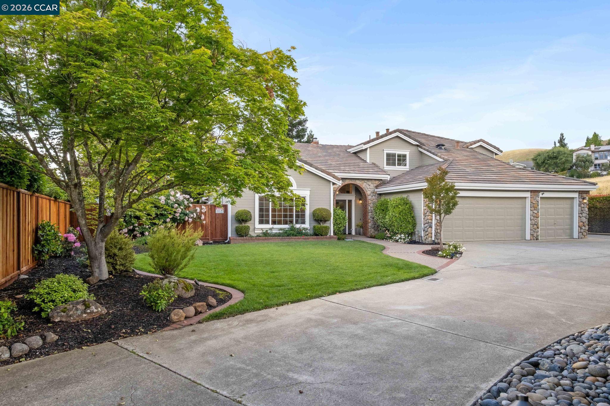 76 Rock Ridge Court Danville, CA 94526 - Photo 3 of 65 a view of a white house with a big yard and potted plants