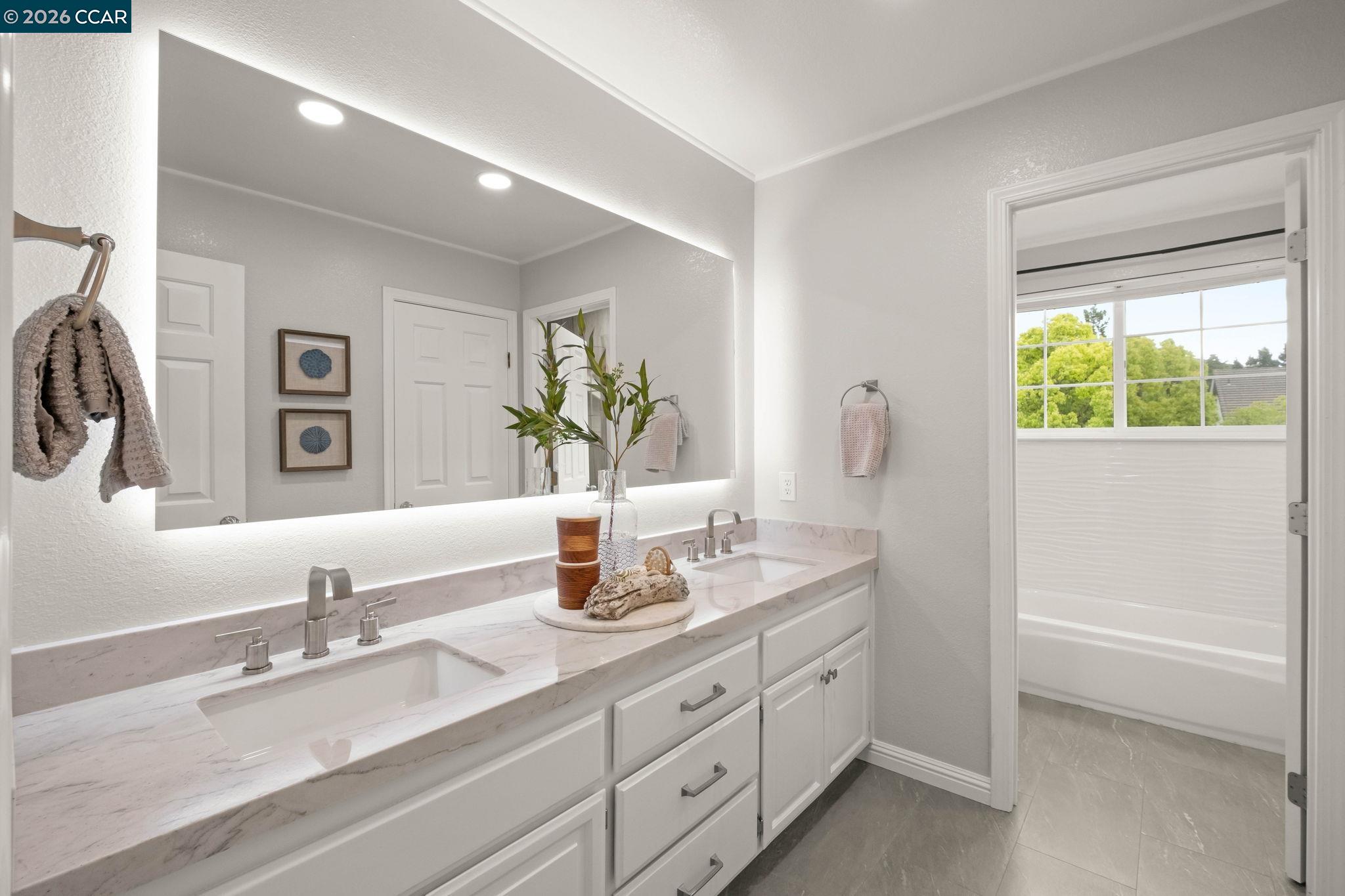 76 Rock Ridge Court Danville, CA 94526 - Photo 38 of 65 a bathroom with a granite countertop sink and a mirror