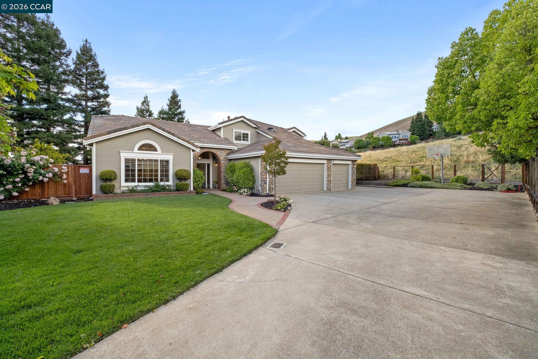 76 Rock Ridge Court Danville, CA 94526 - Photo 4 of 65 a view of a yard in front of a house with a large tree