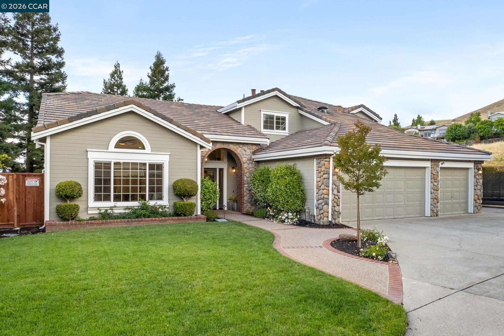 76 Rock Ridge Court Danville, CA 94526 - Photo 6 of 65 a front view of a house with a yard and porch