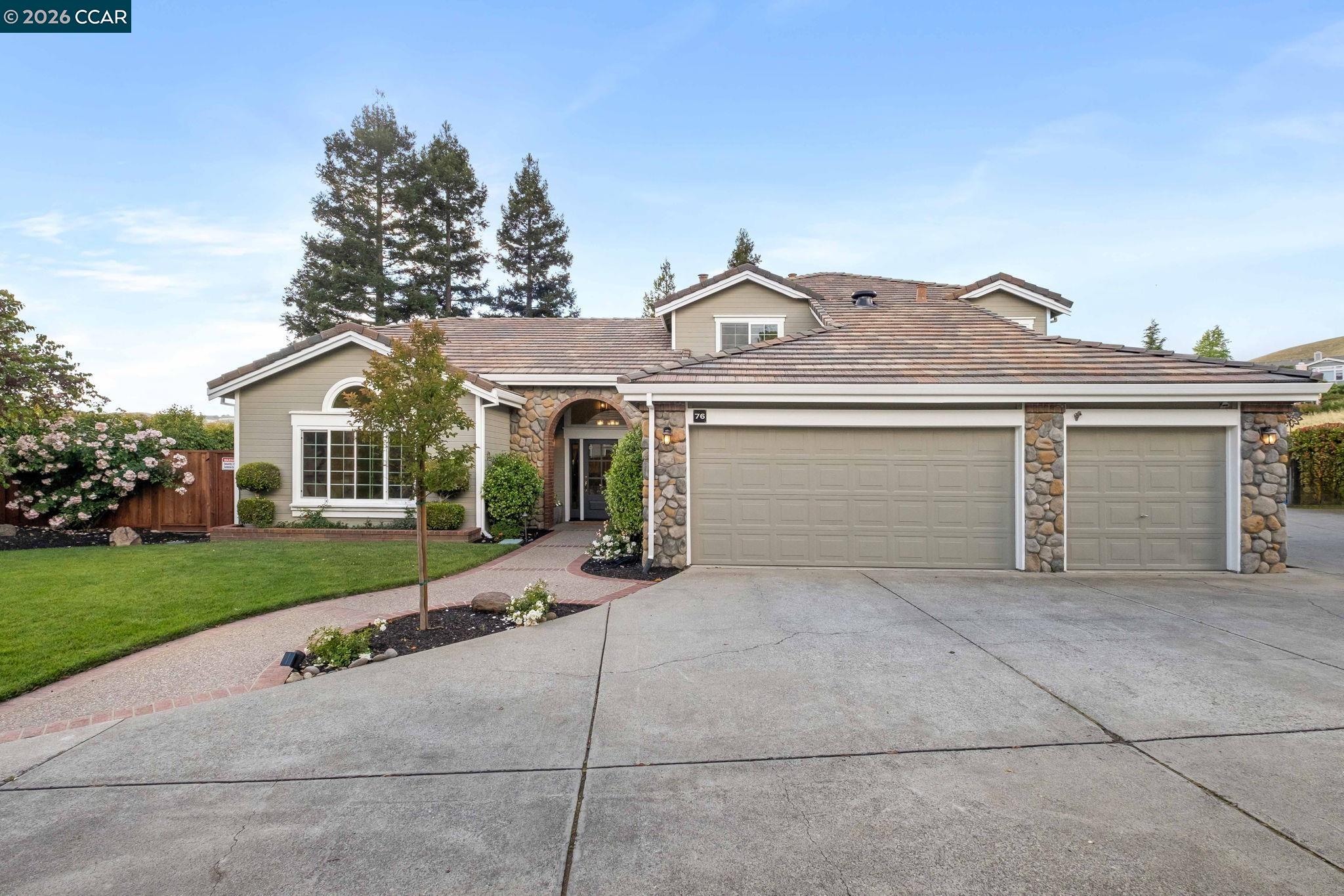 76 Rock Ridge Court Danville, CA 94526 - Photo 7 of 65 a front view of a house with a garden and trees