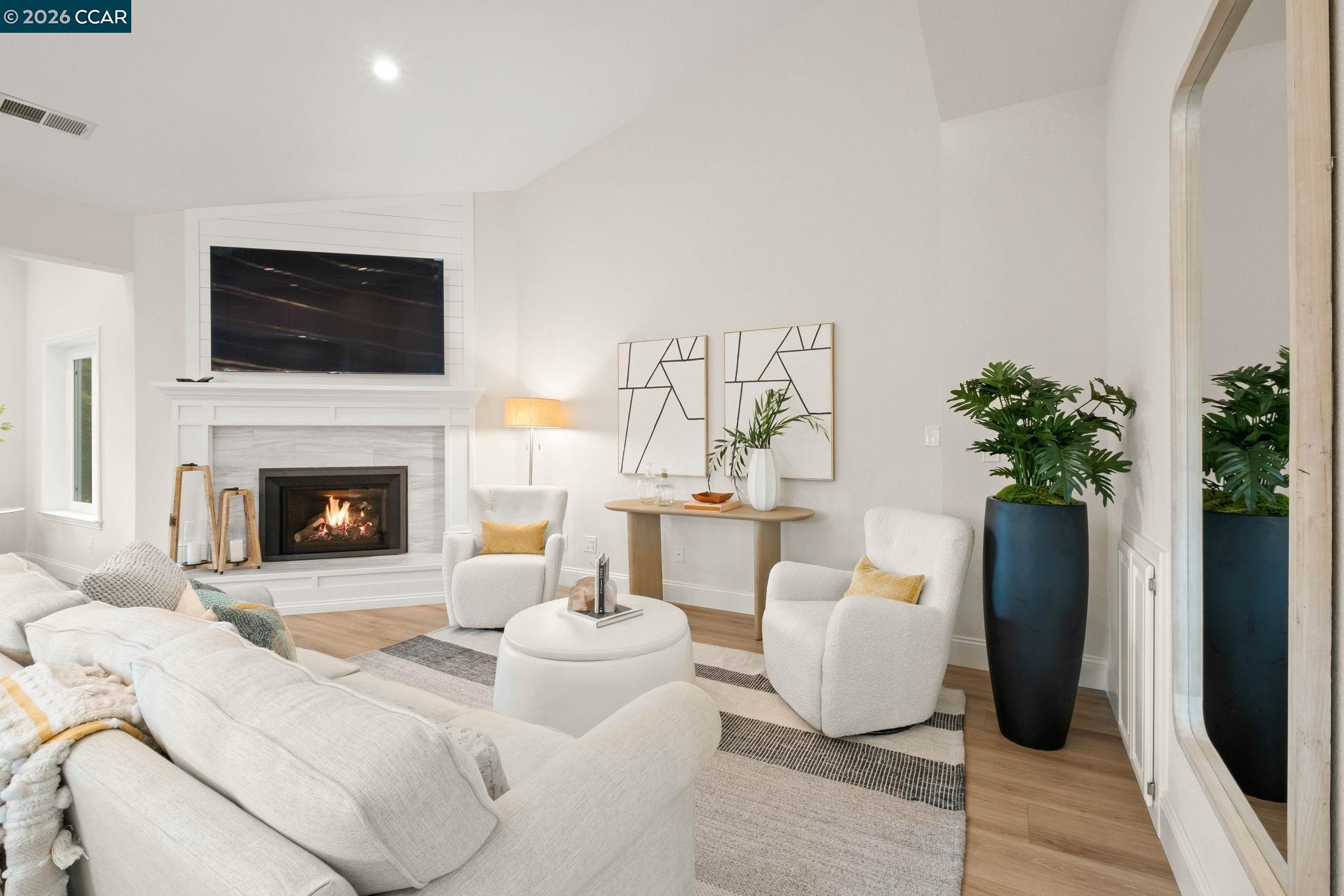 76 Rock Ridge Court Danville, CA 94526 - Photo 9 of 65 a living room with furniture potted plant and a fireplace