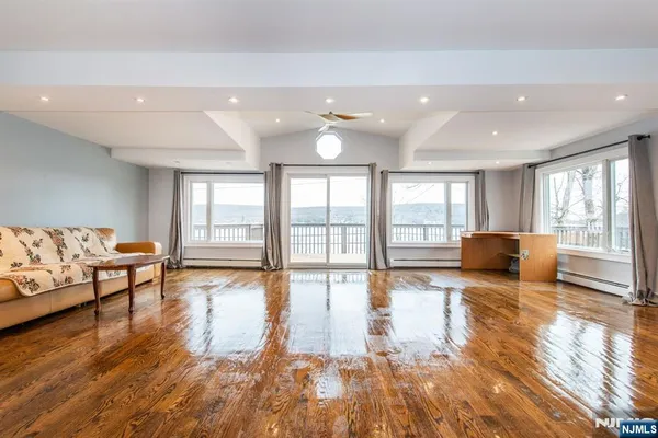 a living room with furniture and a large window with outer view