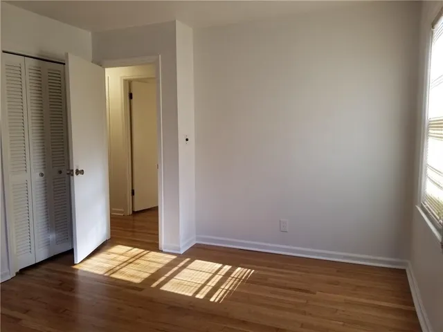 a view of bathroom with wooden floor and window