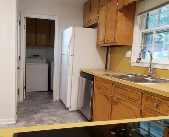 a kitchen with a refrigerator and cabinets