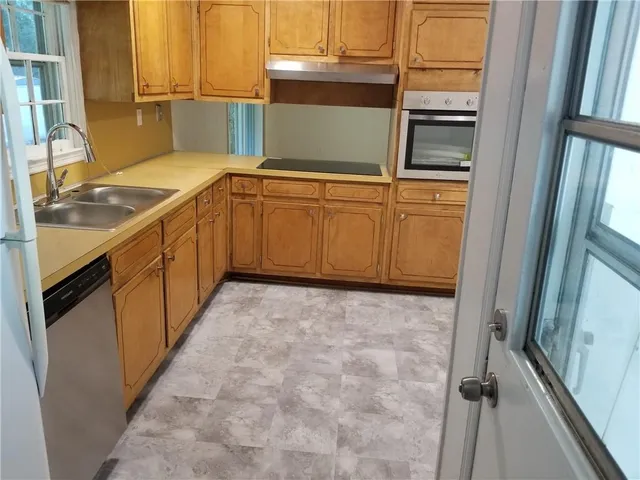 a kitchen with a sink and cabinets