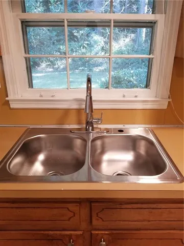 a sink with a cabinet and a window